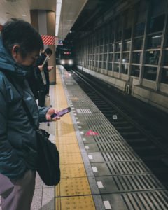 Waiting for train behind yellow line